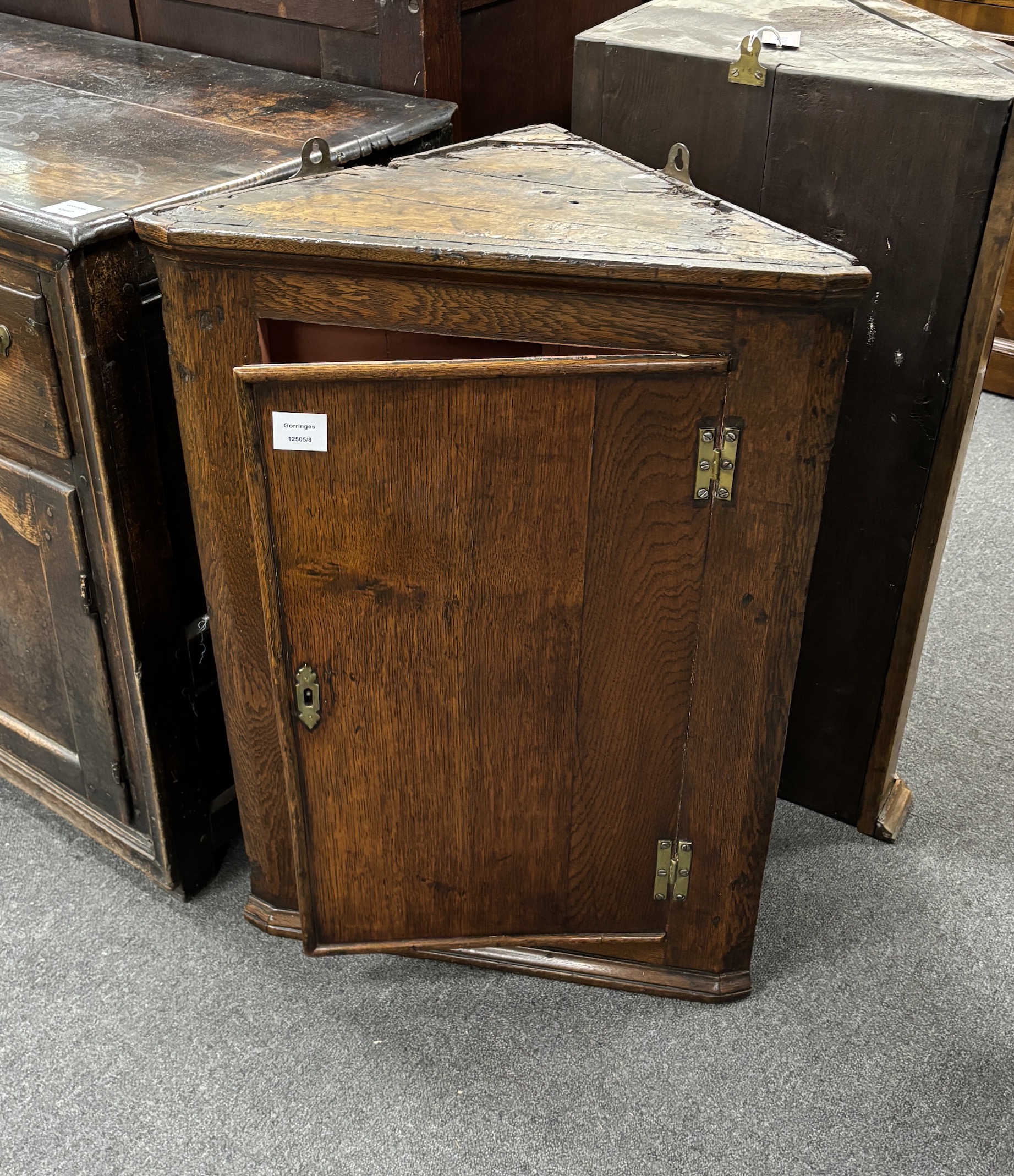 A late 18th century oak hanging corner cupboard, width 55cm, depth 30cm, height 80cm